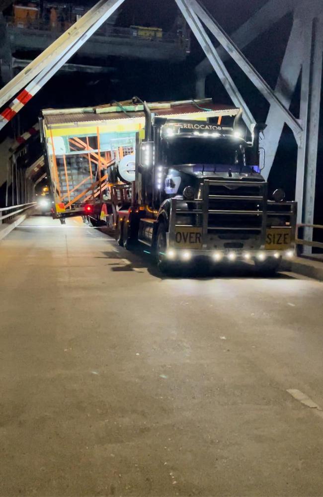 Jo Veneman's truck with an old Bowen house onboard crosses the Burdekin bridge.