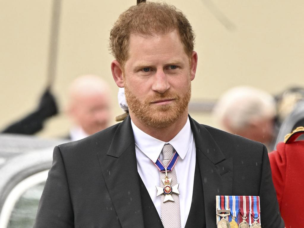 Prince Harry look resigned to being there. Picture: Andy Stenning / POOL / AFP