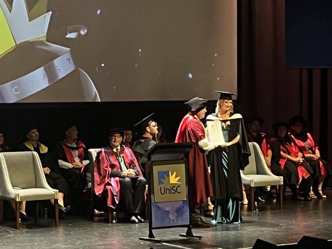 Graduates from the University of the Sunshine Coast's Fraser Coast campus celebrating at the Brolga Theatre.