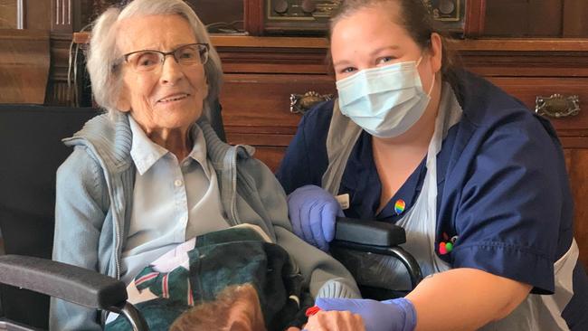 106-year-old Connie Titchen (L), pictured with Sister Kelly Smith, is one of the oldest people in the world to have survived the virus. Picture: AFP..