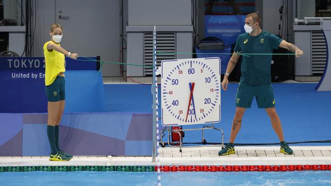 Kyle Chalmers and Madison Wilson stretching before the session. Picture: Alex Coppel.