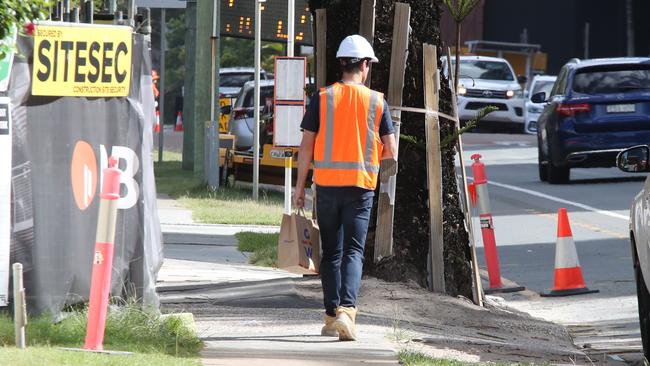 A workman arrives at the Shoreline tower construction site on the Gold Coast to find it locked up. Picture: Glenn Hampson