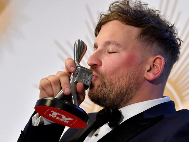 Dylan Alcott is seen kissing the Logie after winning the Graham Kennedy Award in 2019.