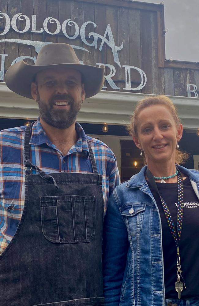 Caz and Matthew Crane own five businesses in the heart of Woolooga, including their most recent addition: The Woolooga Longyard Bar and Grill (pictured behind them). Photo: Elizabeth Neil