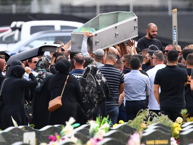 Mourners carry the empty during the burial at Rookwood Cemetery.