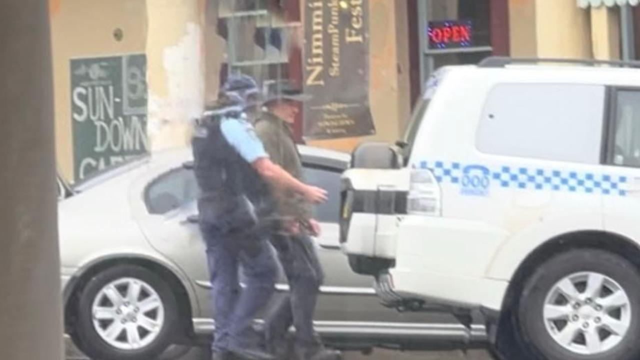 Andrew Thaler is led away by police following the alleged confrontation in Nimmitabel on Sunday. Picture: Supplied / Facebook