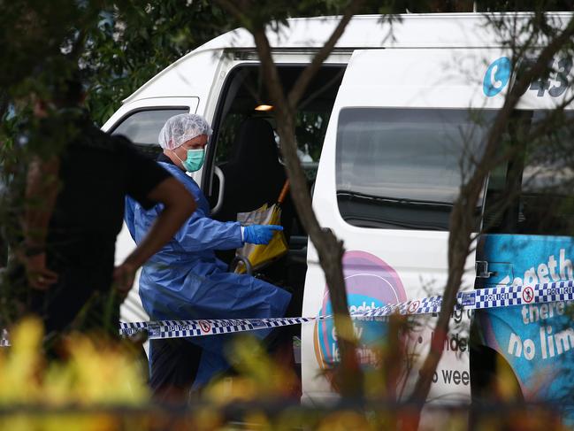 Police officers attend Hambledon State School at Edmonton, where a 3 year old was found dead in a Goodstart Early Learning Centre minibus at around 3:30pm on Tuesday. A police forensic officer inspects the van. PICTURE: BRENDAN RADKE