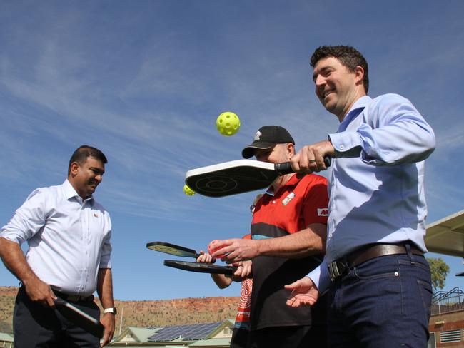 NT people, sport, and culture minister Jinson Charles, Alice Springs Pickleball founder Greg Clarke, and NT planning minister Josh Burgoyne show off their pickleball skills at Albrecht Oval, Larapinta, Alice Springs, May 2, 2025. Picture: Gera Kazakov