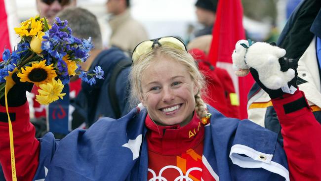 Alisa Camplin draped in Australian flag celebrating winning gold medal in women’s freestyle aerial event at 2002 Winter Olympic Games in Salt Lake City.