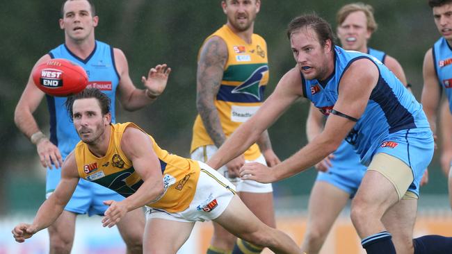 Eagles James Boyd handballs against Sturt on Anzac Day at Unley Oval.