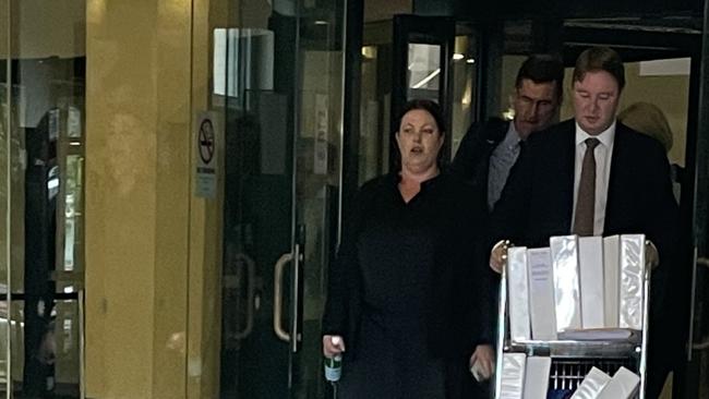 Helen Jacobs leaves Downing Centre Local Court with barrister Brendan Searson (front).