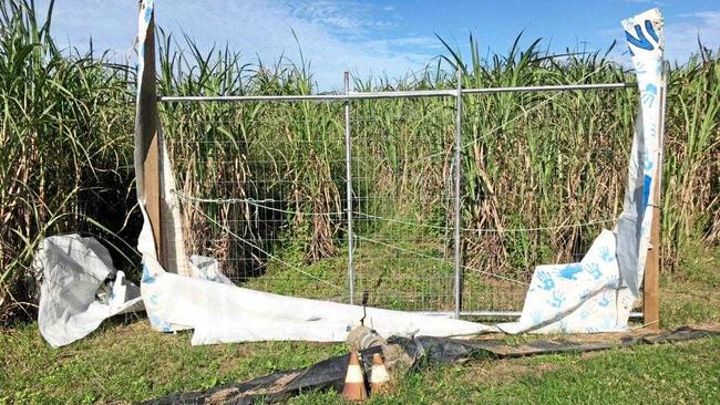 SLASHED: Nichola Borellini&#39;s &#39;Defend our Water&#39; sign was damaged on three occasions, and (inset) Bob Brown with cane farmer Wayne Borellini to his left in front of the Defend our Water sign. Picture: Contributed