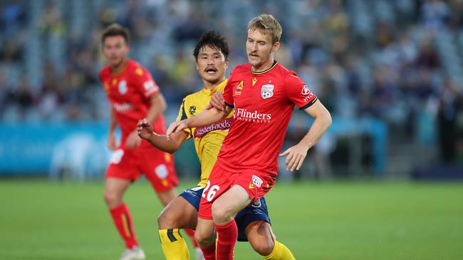 Adelaide United’s Ben Halloran said he should have been awarded a penalty in the Reds 2-1 loss to Central Coast. Halloran contests the ball with Eunsun Kim at Central Coast Stadium. (Photo by Tony Feder/Getty Images)