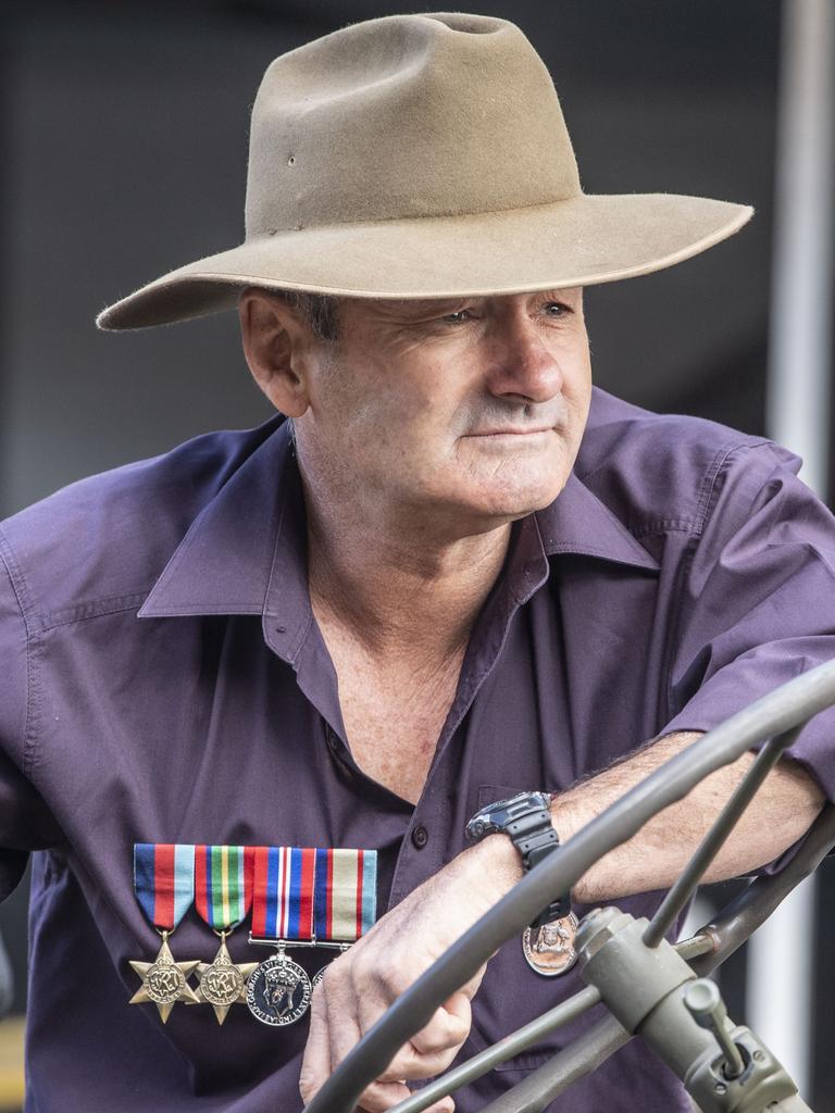 Ken Watson waits to drive his Willys while wearing his grandfathers medals. Assembly in Neil St for the mid morning parade on ANZAC DAY. Tuesday, April 25, 2023. Picture: Nev Madsen.