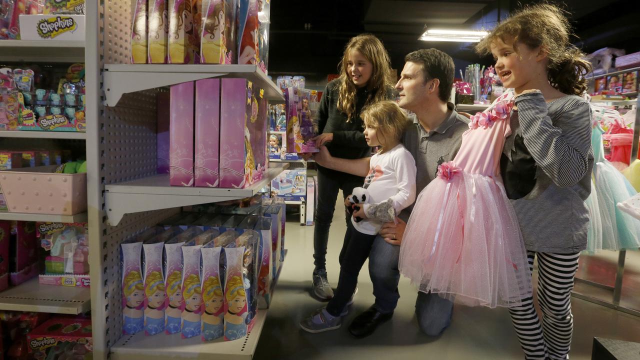 A family browses shelves at Toyworld in Rundle Mall, Adelaide. Picture: Kelly Barnes/The Australian