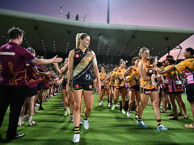 Katie Brennan of the Tigers and Greta Bodey of the Hawks lead the teams onto the grounds ahead of the round eight AFLW match between Hawthorn Hawks and Richmond Tigers at Cazaly's Stadium, on October 20, 2023, in Cairns, Australia. (Photo by Emily Barker/Getty Images)