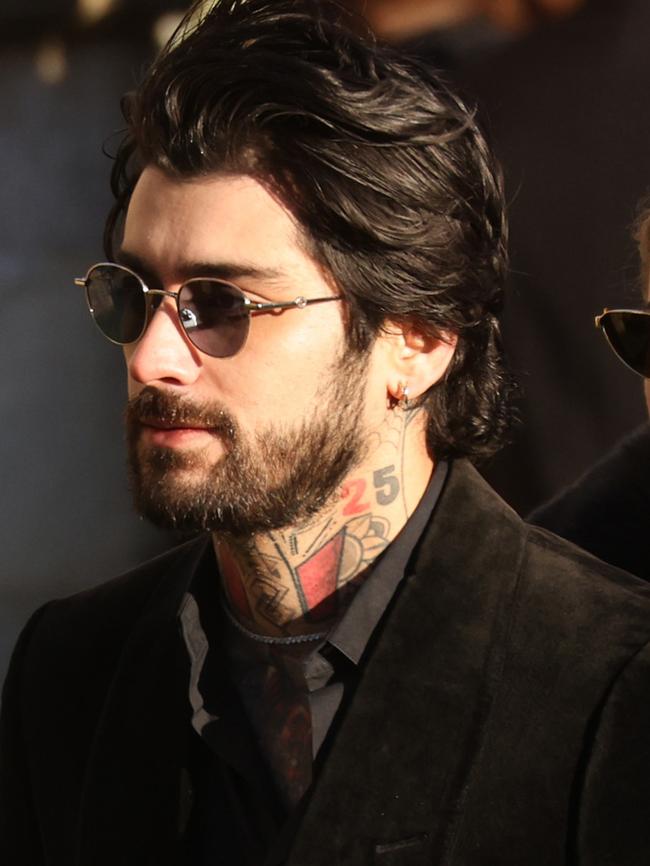 Former One Direction band member Zayn Malik leaves the funeral.