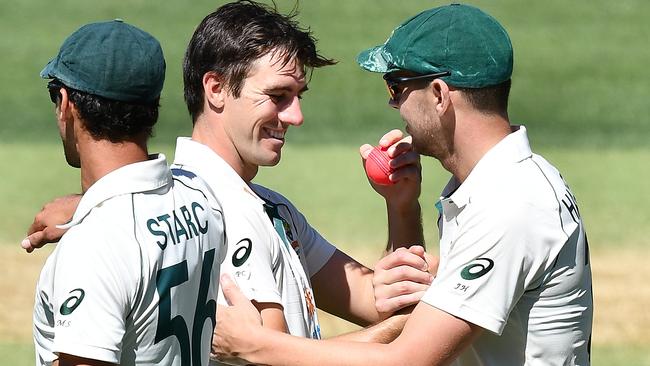 Pat Cummins and Josh Hazlewood celebrate their day out against India. Picture: Getty Images