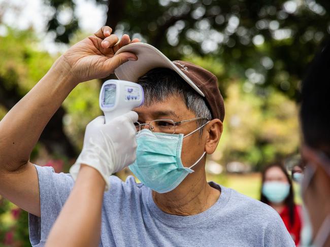 A man wearing a surgical mask correctly fitted over the nose and mouth. Picture: Getty Images