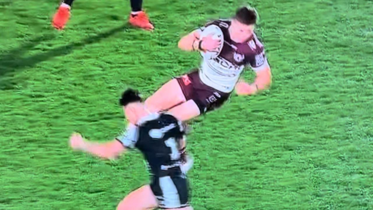 Manly's Reuben Garrick is tackled in the air.