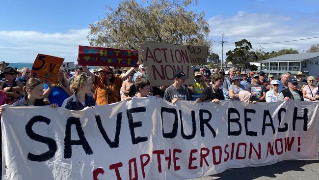 Around 100 residents turned out at an LNP/Bundaberg council media conference calling for the state government to "urgently" approve works on the Woodgate beach sea wall project to protect the beach from further erosion.