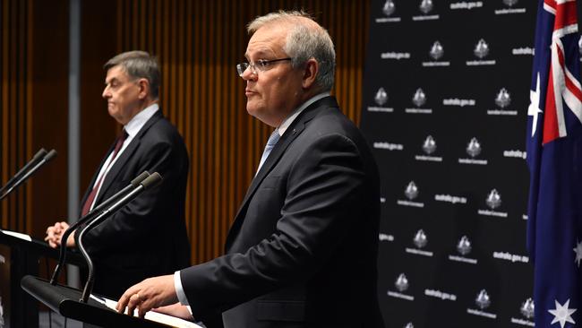 Prime Minister Scott Morrison (right) alongside Chief Medical Officer Brendan Murphy (left) during a press conference at Parliament House on Friday.