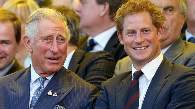 LONDON, ENGLAND - SEPTEMBER 10:  Prince Charles, Prince of Wales and Prince Harry laugh during the Invictus Games Opening Ceremony on September 10, 2014 in London, England. The International sports event for 'wounded warriors', presented by Jaguar Land Rover, is just days away with limited last-minute tickets available at www.invictusgames.org  (Photo by Chris Jackson/Getty Images)