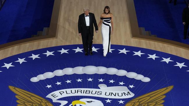 President Donald Trump and First Lady Melania Trump walk to the stage to dance at the Commander in Chief Ball. Picture: AP