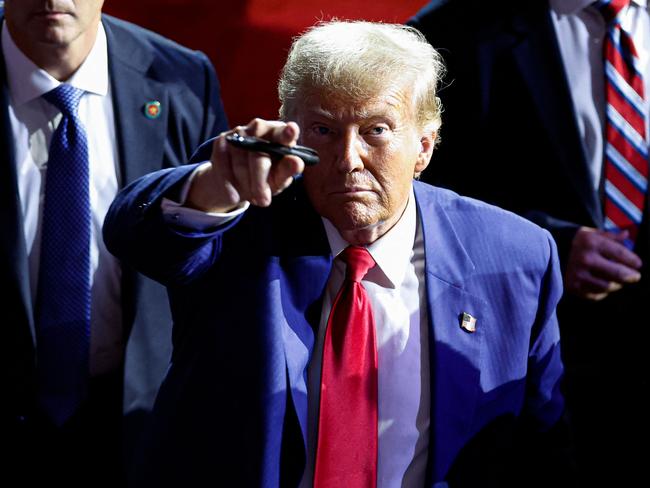 TOPSHOT - Former US President and Republican presidential candidate Donald Trump points to the crowd as he leaves after speaking during a town hall meeting in La Crosse, Wisconsin, on August 29, 2024. (Photo by KAMIL KRZACZYNSKI / AFP)