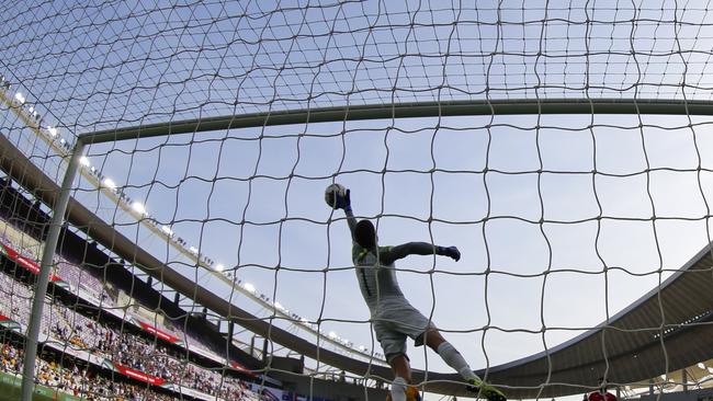 Ryan goes airborne to make a save against Jordan. (AP Photo/Hassan Ammar)