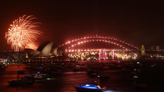 The Harbour Bridge lights up for the family fireworks, which were held off from 9pm to 9.15pm. Picture: Rohan Kelly