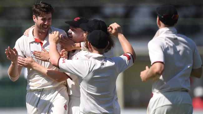 Tom O'Donnell celebrates a wicket with Essendon teammates. Picture: Julian Smith