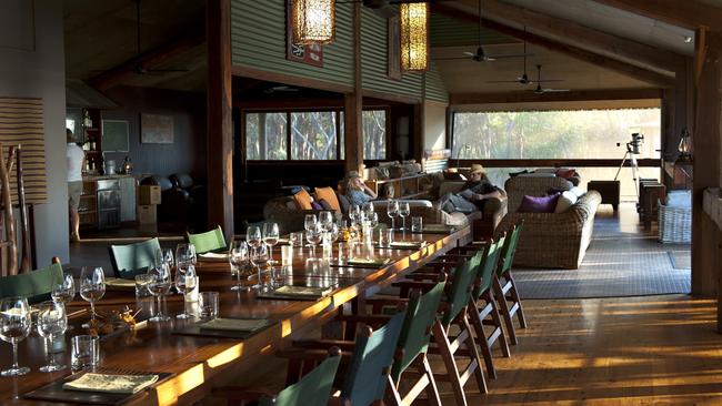 Guides join guests at the long table for dinner.