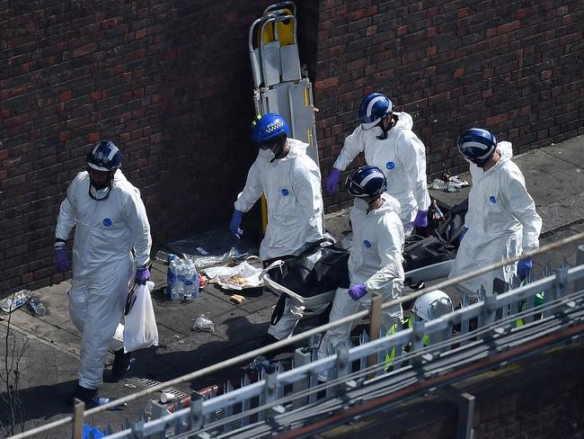 Police forensics remove a body from the gutted apartment tower. Picture: Leon Neal/Getty Images