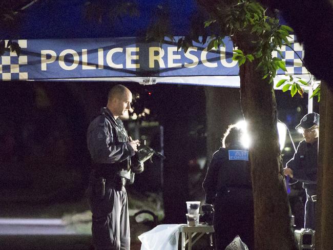 A federal police officer with a gas mask around his neck just before going into an apartment block in  Lakemba, during the counter-terrorism raids on July 29, 2017. Picture: Damian Shaw