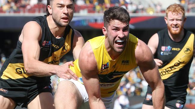 SANFL GRAND FINAL - Sunday, 3rd October, 2021. Glenelg v Eagles at The Adelaide Oval. Rory Lehmann of the Eagles handless the ball away from Brett Turner of Glenelg Picture: Sarah Reed