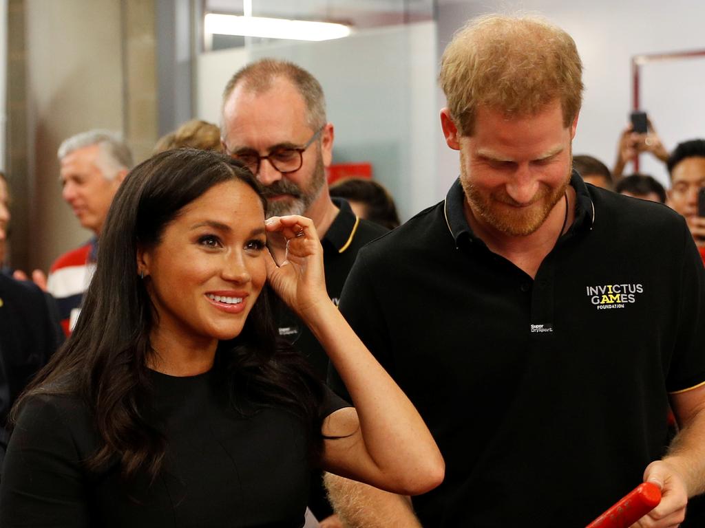 Harry and Meghan in the change rooms before the game. Picture: Getty