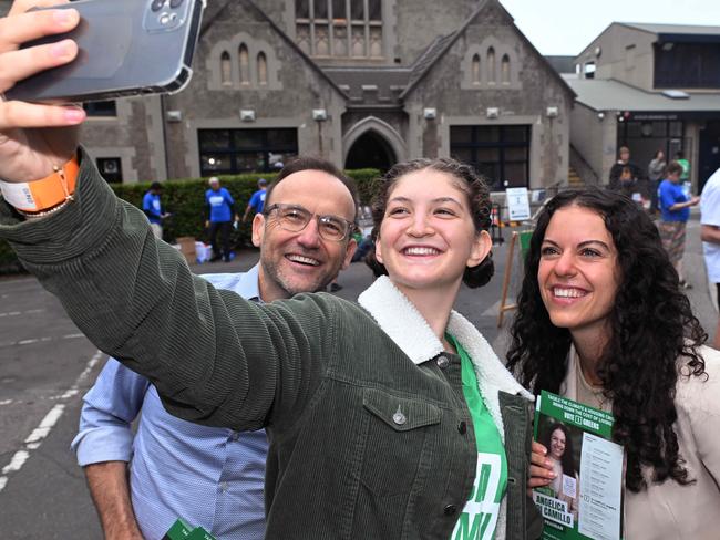 Greens Leader Adam Bandt with Greens volunteer Carmena Witham and Greens candidate Angelica Di Camillo at the Fawkner Park booth. Picture: Josie Hayden