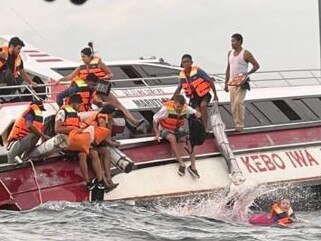 Tourists flee a boat in Bali