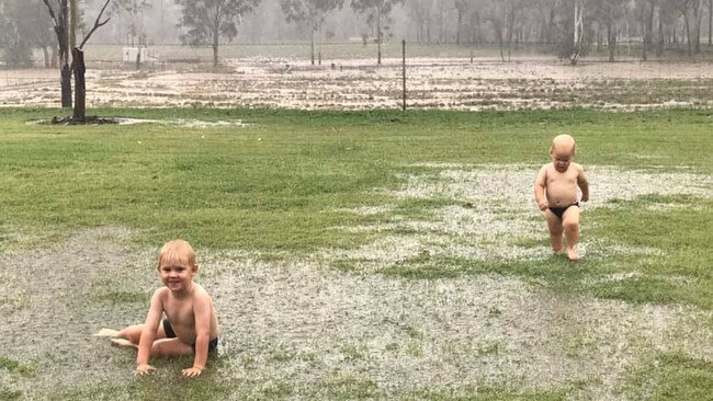 Jack and Ryan Flohr play in the rain for the first time. Picture: Case Flohr