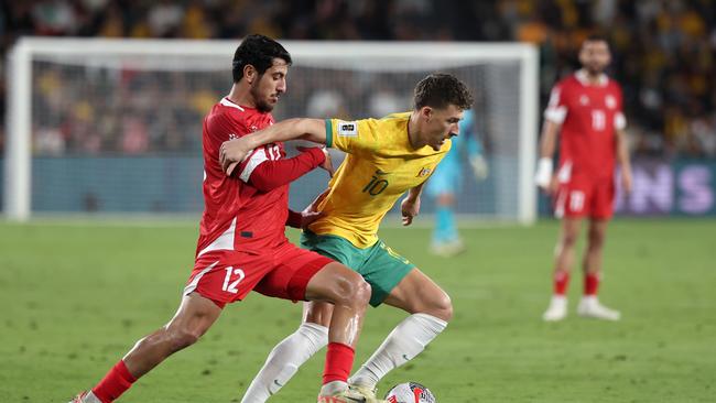 Socceroo Ajdin Hrustic (right) battles with Lebanon’s Hasan Srour during Australia’s 2-0 win on Thursday night. Picture: Cameron Spencer/Getty Images