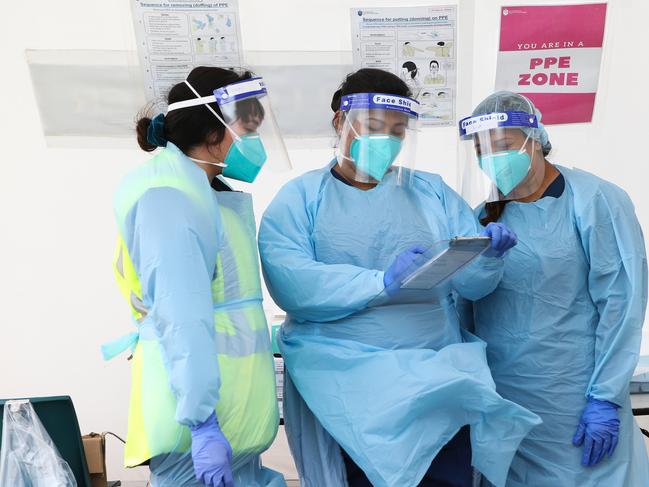 SYDNEY, AUSTRALIA - SEPTEMBER 02, 2020: Nurses seen checking documents and changing gear in between testing locals at the Bondi Drive Thru Covid Testing Clinic in, Sydney Australia, on SEPTEMBER 02 2020. Picture: NCA NewsWire / Gaye Gerard