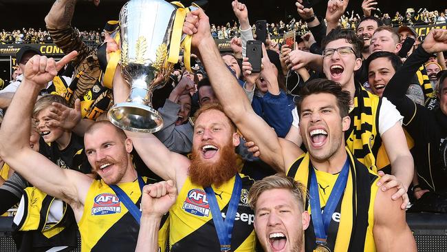 Nick Vlastuin, centre, and his famous beard celebrate the 2017 premiership victory. Picture: Julian Smith/AAP