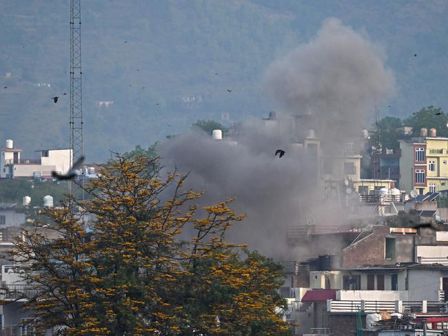 Smoke billows after an artillery shell landed in the main town of Poonch district in India's Jammu region. Picture: Punit Paranjpe / AFP