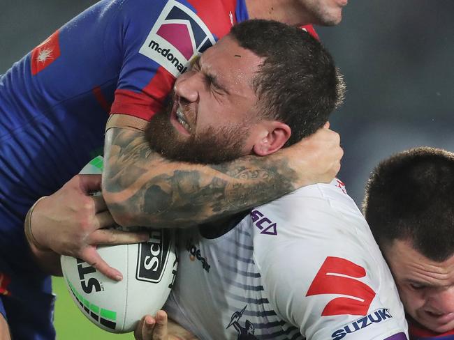 GOSFORD, AUSTRALIA - JUNE 13: Kenneath Bromwich of the Storm is tackled during the round five NRL match between the Newcastle Knights and the Melbourne Storm at Central Coast Stadium on June 13, 2020 in Gosford, Australia. (Photo by Matt King/Getty Images)