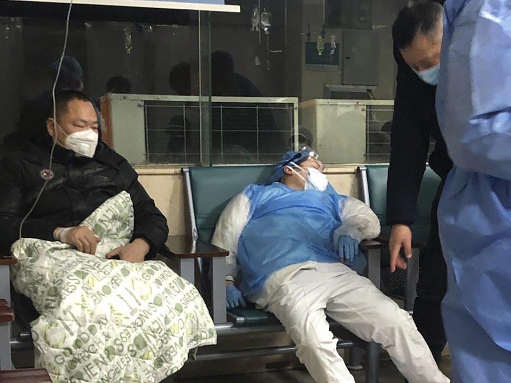 What awaits: medical worker next to a patient in a Wuhan hospital. Picture: AP.