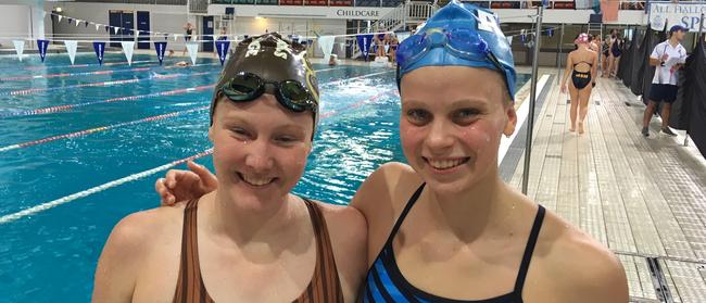 All Hallows School 50m butterfly winner Elizabeth Dekkers, right, with second placed Lily Carrick of St Rita's College at the CaSSSA Cup swimming carnival held at Chandler.