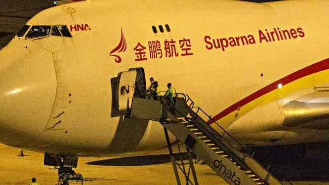 Suparna Airlines flight Y87447 from Wuhan lands at Sydney intentional airport last night. Picture: Adam Yip