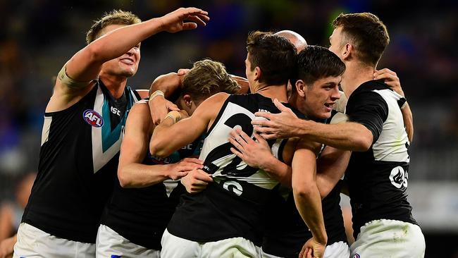 Xavier Duursma, Connor Rozee and Zak Butters celebrate a Port Adelaide goal together in Friday night’s win over West Coast. Picture: Daniel Carson (Getty)