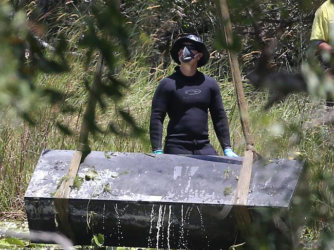 Toolbox murder -  Police retrieve a metal box from a dam near Srubby Creek in Kingston, double murder Logan. Pic Jono Searle.